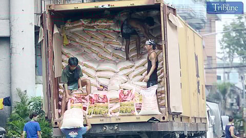 Workers unloaded premium sacks of rice from a trailer truck in Caloocan City on Thursday, 3 October 2024. Agriculture Secretary Francisco Tiu Laurel Jr. said the agency expects global rice prices to decrease following the lifting of India's export ban, potentially stabilizing the international supply.
