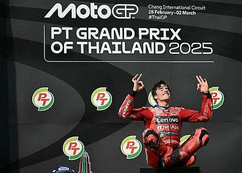 Ducati Lenovo's Spanish rider Marc Marquez celebrates on the podium after winning the MotoGP Thailand Grand Prix at the Buriram International Circuit in Buriram on 2 March 2025.