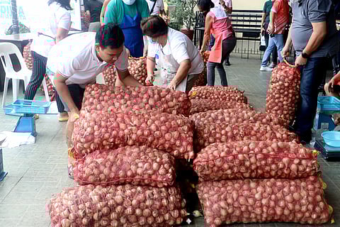 SOME importers are bringing onions into the country by declaring them as other goods. In a recent development, the Department of Agriculture seized two container vans of onions that were declared as processed food in Subic. File photo shows onions bought from Pangasinan farmers.
