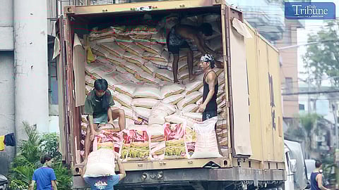 Workers unloaded premium sacks of rice from a trailer truck in Caloocan City on Thursday, 3 October 2024. Agriculture Secretary Francisco Tiu Laurel Jr. said the agency expects global rice prices to decrease following the lifting of India's export ban, potentially stabilizing the international supply.