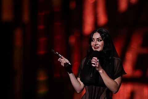British singer Charli XCX celebrates on stage after receiving the award for Song of the year during the BRIT Awards 2025 in London on 1 March 2025.