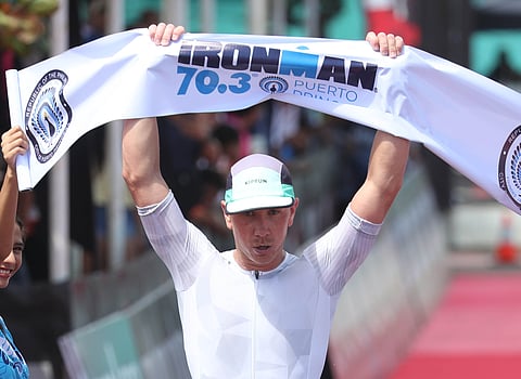 Bastien Poupelain celebrates after crossing the finish line to mark his victory in the men’s division of the IRONMAN 70.3 Puerto Princesa on Sunday.