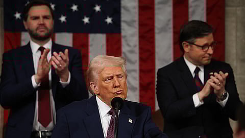 President Donald Trump addresses a joint session of Congress at the United States Capitol on 4 March 2025 in Washington, DC. Vice President JD Vance and Speaker of the House Mike Johnson applaud behind him.