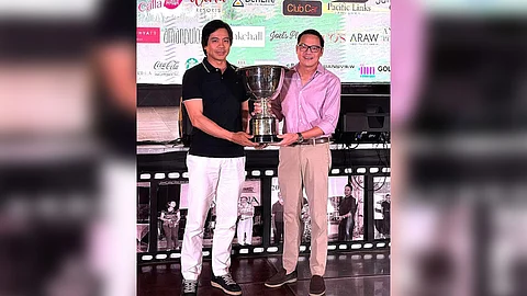 Michael Kho (right) and Eddy Fianza show off the trophy after bagging the overall net team title in the 27th Sta. Elena Cup.