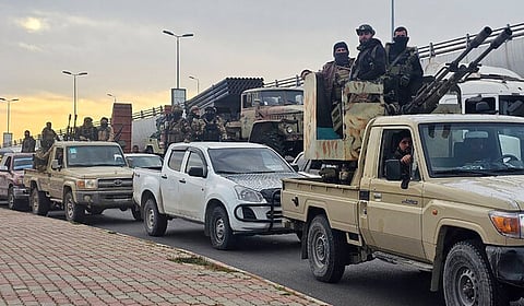 This handout picture released by the official Syrian Arab News Agency (SANA) shows members of the Syrian security forces entering the Mediterranean city of Tartous to reinforce government troops in clashes with militants loyal to deposed ruler Bashar al-Assad, on March 7, 2025.