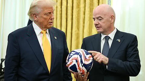 FIFA president Gianni Infantino (R) presents US President Donald Trump with the new FIFA Club World Cup official ball in the Oval office