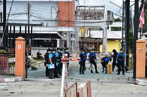 Thailand's forensic police officers inspect the site of an attack that killed two defence volunteers and injured 12 others, outside the district office of Sungai Kolok in the southern Thailand province of Narathiwat on March 9, 2025. A low-level conflict has simmered in the country's southernmost provinces since 2004, killing more than 7,000 people, as rebels in the Muslim-majority region battle for greater autonomy from the state.
