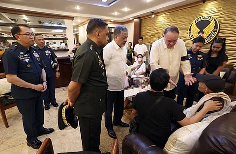 Special Assistant to the President Antonio Lagdameo Jr. and Defense Secretary Gilbert Teodoro console the families of the two pilots who perished in the fatal fighter jet crash.