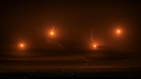 (FILES) Israeli flares light the sky above Khan Yunis in the southern Gaza Strip, on December 3, 2023, as fighting resumed after the expiration of a seven-day truce between Israel and Hamas militants.