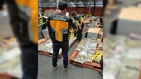 Operatives from the Bureau of Customs inspect the approximately P29 million worth of suspected marijuana and kush oil hidden inside two balikbayan boxes that arrived from Canada.