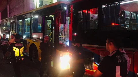 Members of the Metropolitan Manila Development Authority check on the buses that were involved in a collision along the Guadalupe EDSA Bus Carousel on Monday night. The incident has injured 31 individuals.