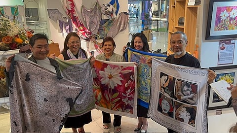 Artistic collaboration Holding the scarves featuring their art are (from left) JJ Duque, Karina Orozco, Atty. Gladys Tiongco, Corso Como owner Imelda Menguito-Sciandra (for Ofelia Gelvezon-Tiqui, who is based in France) and Danger Sanchez.