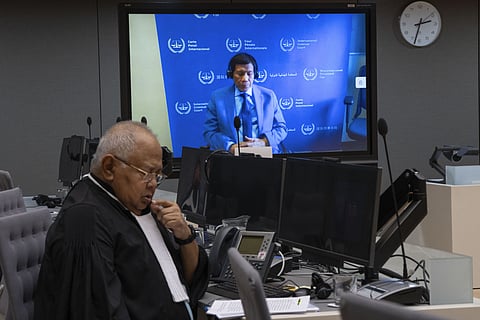 (FILE PHOTO) Former Philippine President Rodrigo Duterte is seen on a screen with his lawyer Salvador Medialdea (L) in the courtroom during his first appearance before the International Criminal Court (ICC) on charge of crimes against humanity over his deadly crackdown on narcotics, in The Hague on 14 March 2025. The 79-year-old, the first ex-Asian head of state to face charges at the ICC, followed by videolink during a short hearing to inform him of the crimes he is alleged to have committed, as well as his rights as a defendant. Duterte stands accused of the crime against humanity of murder over his years-long campaign against drug users and dealers that rights groups said killed thousands.