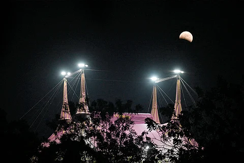 PHOTO shows the ‘Blood Moon,’ as seen past a circus tent in San Salvador, El Salvador on 14 March 2025, during a lunar eclipse.