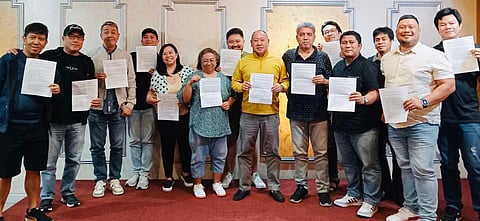 Members of the Philippine Sportswriters Association board of directors show their approved charter during their executive council meeting recently.