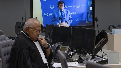 Former Philippine President Rodrigo Duterte is seen on a screen with his lawyer Salvador Medialdea (L) in the courtroom during his first appearance before the International Criminal Court (ICC) on charge of crimes against humanity over his deadly crackdown on narcotics, in The Hague on 14 March 2025.