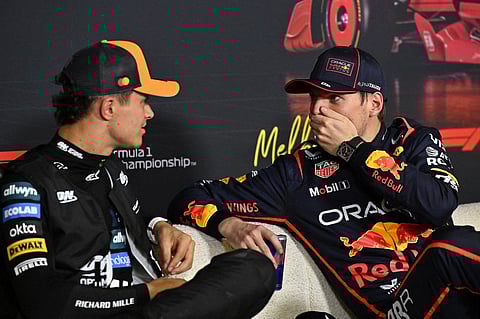 McLaren's British driver Lando Norris (L), who took pole position in the qualifying session, speaks with Red Bull Racing's Dutch driver Max Verstappen (R) who finished third during a press conference at the Formula One Australian Grand Prix at the Albert Park Circuit in Melbourne on 15 March 2025.