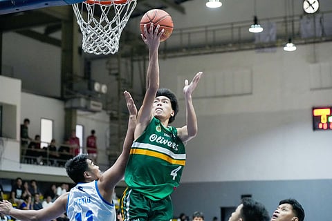 Rodel Renon drives his way to 29 points in Olivarez College’s 87-83 win over Imaculada Concepcion College in Saturday’s action in the UCAL.