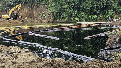 Workers of Petroecuador work on the cleaning of an oil spill at the Chucaple River in the province of Esmeraldas, Ecuador on 15 March 2025.
