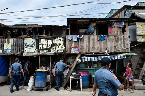 POLICE officers conduct an ‘Oplan Tokhang’ or house-to-house campaign on illegal drugs at an informal settlers’ community in Manila in October 2016. Six years later, the Duterte administration would log nearly 7,000 people dead in what it described as mostly legitimate police operations that also resulted in law enforcement personnel being killed.