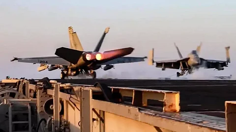 US Navy F/A-18 fighter aircraft operate on an aircraft carrier at sea reportedly during operations against Yemen Huthi rebels