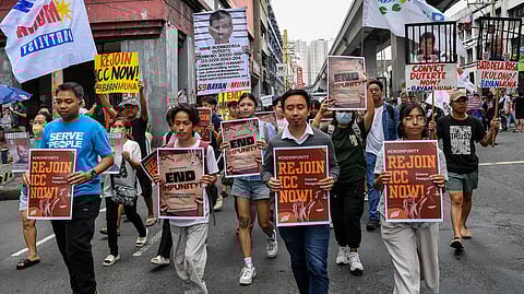 Protesters carrying placards showing former president Rodrigo Duterte (L) and Senator Ronald dela Rosa (R) in a prison cell take part in a rally near Malacanang palace in Manila on 17 March 2025. The protesters are calling on the government to rejoin the International Criminal Court (ICC), days after former Philippine president Rodrigo Duterte was arrested and brought to the Hague to face charges of crimes against humanity over his deadly crackdown on drugs.