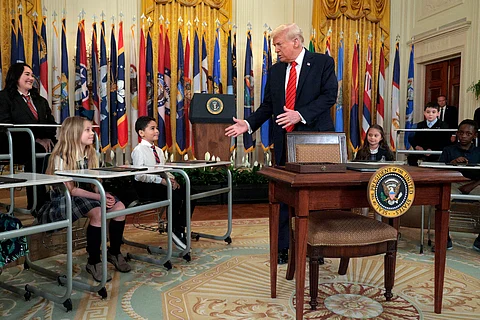 PRESIDENT Donald Trump greets school children before signing an executive order to reduce the size and scope of the Education Department during a ceremony in the East Room of the White House on 20 March 2025 in Washington, DC.