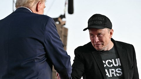 (FILES) Tesla CEO Elon Musk (R) joins former US President and Republican presidential candidate Donald Trump during a campaign rally at the site of his first assassination attempt in Butler, Pennsylvania on 5 October 2024. Donald Trump announced 12 November 2024 that the world's richest man, Elon Musk, will lead a new US government efficiency group tasked with cutting federal waste, as the Republican president-elect added a series of seasoned figures and hardliners to his incoming administration. Musk became a key ally to Trump during his campaign, reportedly spending over $100 million to help the Republican win and repeatedly boosting Trump's candidacy on X, the platform he owns.