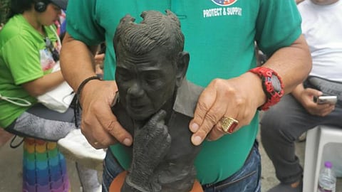 Ranque holds a paper mache bust of FPRRD during the 15 March prayer rally in Liwasang Bonifacio in Manila.