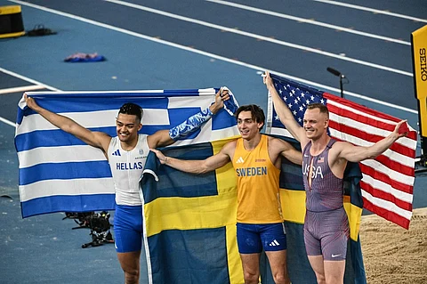 Sweden's Armand Duplantis (C), Greece's Emmanouil Karalis (L) and USA's Sam Kendricks celebrate after winning the men's pole vault final during the World Athletics Indoor Championship in Nanjing, in eastern China's Jiangsu province, on 22 March 2025.
