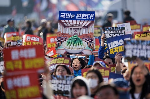 Protesters attend a demonstration against impeached South Korean President Yoon Suk Yeol in Seoul on 22 March 2025.