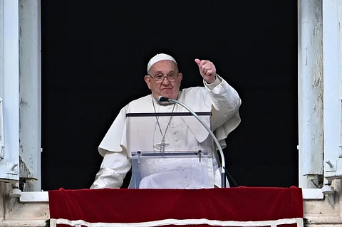 (FILES) Pope Francis gestures to the crowd from the window of the Apostolic Palace overlooking St Peter's Square during the Epiphany Angelus prayer, in the Vatican, on 6 January 2025. Pope Francis will make his first public appearance on 22 March, 2025 with a blessing and a wave from a window at Rome's Gemelli hospital where he was admitted on 14 February.