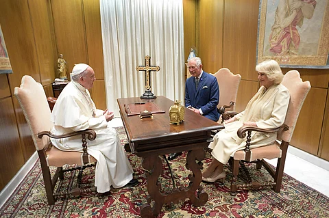 A handout photograph released by the Vatican press office shows Pope Francis (L) speaking with then Britain's Prince Charles and his wife Camilla, Duchess of Cornwall, during a private audience on April 4, 2017 at the Vatican. Britain's King Charles III and Queen Camilla have postponed a planned state visit to the Vatican in early April following medical advice from the pope's doctors, Buckingham Palace said on March 25, 2025. Charles, who is the head of the Church of England, had been scheduled to meet his Catholic counterpart on April 8.
