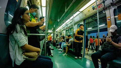 Passengers of the LRT-1 wait for the train to continue its journey after stopping at one of its stations in Manila on Wednesday. The LRT-1 management announced that it will be extending its weekday operations.