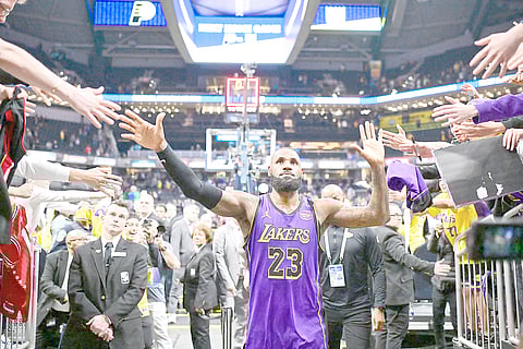 LeBron James and his fans celebrate his tip-in that gave the Los Angeles Lakers a 120-119 win over the Indiana Pacers in their NBA regular season game.