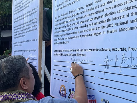 Local candidates in Valenzuela City, along with members of various government agencies and civil organizations, sign a peace pact on Thursday, 27 March, ahead of the midterm elections.