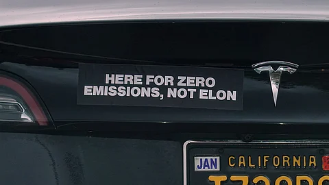 SAN RAFAEL, CALIFORNIA - 27 MARCH: A bumper sticker protesting Tesla CEO Elon Musk is shown on a Tesla car on 27 March 2025 in San Rafael, California. The backlash continues to grow against Tesla over Elon Musk and DOGE's handling of government jobs. Elon Musk is the CEO of Tesla.
