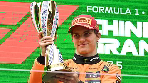 MCLAREN’s Australian driver Oscar Piastri celebrates on the podium with his trophy after winning the Formula One Chinese Grand Prix.