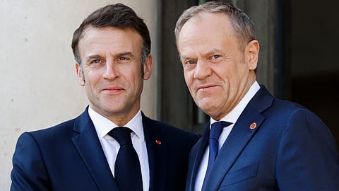 France's President Emmanuel Macron welcomes Poland's Prime Minister Donald Tusk as he arrives for a "coalition of the willing" summit at the Elysee Palace in Paris on 27 March 2025.