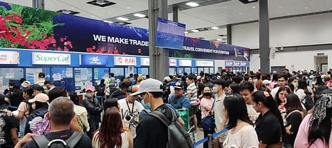 Passengers in long queues while getting vessel journey tickets in Batangas Port during Holy Week 2023 going to provinces.