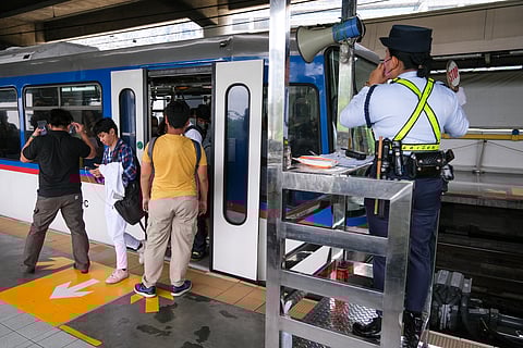 A security personnel manages the flow of commuters entering and exiting the Metro Rail Transit Line 3 train at the Ortigas Station on EDSA on Friday. Recently, MRT-3 management issued an advisory listing prohibited items in accordance with safety regulations and the Office for Transportation Security Memorandum Circular No. 004, series of 2019.