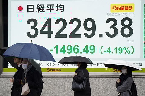An electronic board showing the numbers of the Nikkei Stock Average on the Tokyo Stock Exchange is displayed along a street in Tokyo on 3 April 2025.