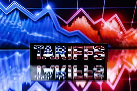 Stock market index graphs and the word ‘Tariffs’ written in the colors of the US flag appear in Paris on 4 April 2025. Markets extended a global selloff as countries around the world reeled from the US President’s trade war, but the White House insisted the American economy will emerge victorious.