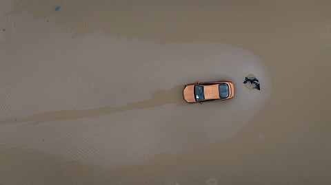 In an aerial view, floodwaters surround a car on 6 April 2025 in Poplar Bluff, Missouri. Thunderstorms, heavy rains, high winds, and tornadoes have plagued the regions for several days, causing widespread damage.