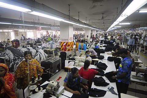 (FILES) This file photo taken on June 23, 2010 shows Bangladeshi women working in a garments factory in Ashulia. Global retailers fleeing China's rising labour costs now find themselves facing growing pressure for higher wages in countries from Bangladesh to Cambodia, Vietnam, India and Indonesia.