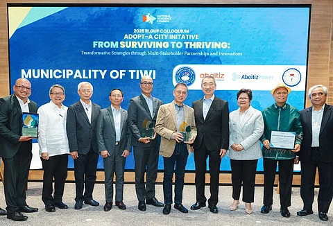 AP Renewables Inc. president and COO Jeffrey Estrella (5th from left), and Tiwi Mayor Jaime Villanueva (5th from right), with their plaques of recognition from National Resilience Council (NRC), led by its president and chairman Hans Sy (4th from right), during an NRC conference in Pasay City. With them is DENR Undersecretary Marilou G. Erni (3rd from right).
