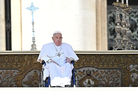 Pope Francis, seen wearing an oxygen breathing apparatus, looks on during a surprise appearance at the end of a mass for the sick and healthcare workers on St. Peter's square in The Vatican, on April 6, 2025.