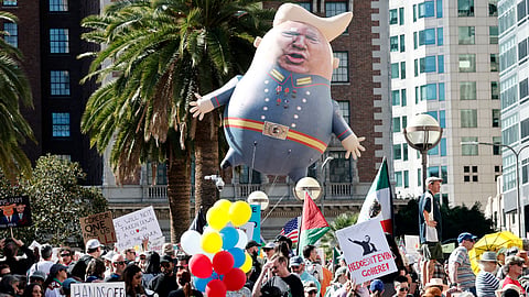 LOS ANGELES, CALIFORNIA: Protestors demonstrate at a 'Hands Off!' protest against the Trump administration on 5 April 2025 in Los Angeles, California. Protests against Trump administration policies and Elon Musk's Department of Government Efficiency (DOGE) are being held nationwide in what organizers are calling a National Day of Action.