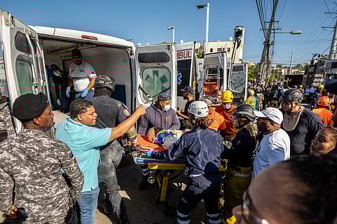 Members of Civil Defense and firefighters carry a wounded man following the coillapse of the Jet Set nightclub roof, in Santo Domingo, on 8 April 2025.
At least 27 people were killed when the roof of a nightclub in the Dominican Republic collapsed early Tuesday morning, emergency services said, with rescue operations still underway.
