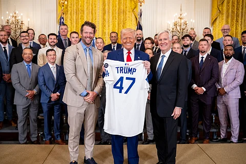 United States President Donald Trump displays a Los Angeles Dodgers jersey given to him by pitcher Clayton Kershaw and team owner Mark Walter during an event honoring the 2024 World Series champions in the East Room of the White House in Washington.